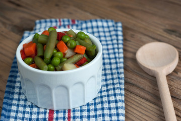 Vegetable soup on old wooden table