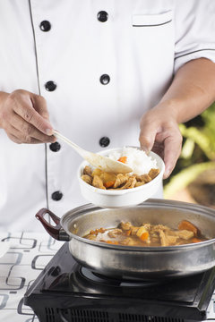 Chef shovel Japanese pork curry with steam rice