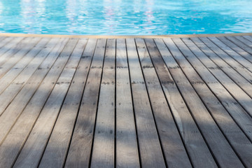 wooden floor beside swimming pool