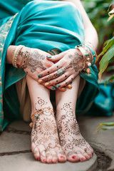 Indian hindu bride with mehendi heena on hands.