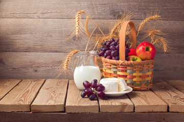 Jewish holiday Shavuot celebration. Basket with fruits and milk