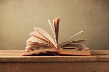 Open old book on wooden table