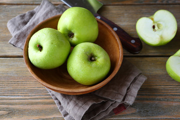 Ripe apple in a clay bowl on napkin