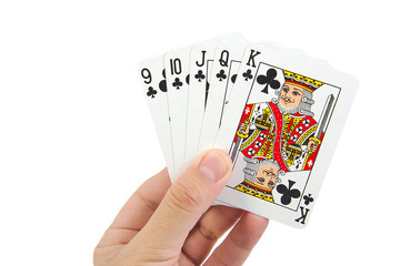A royal straight flush playing cards poker hand in clubs on a