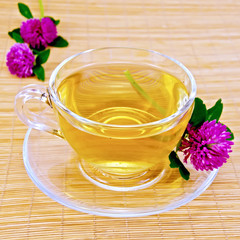 Herbal tea with clover on bamboo napkin