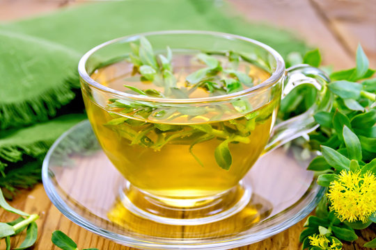 Herbal tea with Rhodiola rosea and napkin on board