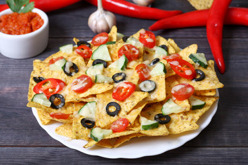 Mexican hot nachos with vegetables and chili