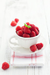 Cup of juicy raspberries