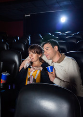 Naklejka premium Couple Watching Movie In Cinema Theater