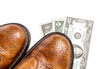 Fototapeta premium Dollars under a pair of Shoes