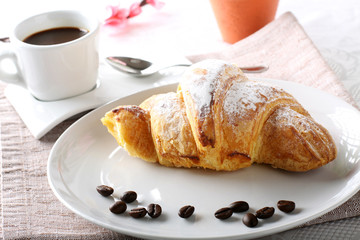 Breakfast with coffee and croissants
