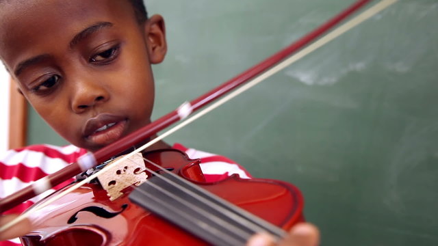 Cute pupil playing violin