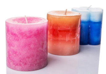 Pink, blue and brown colored aromatic candle 