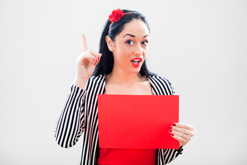 Woman holding red paper with blank space for text message