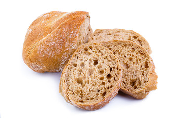Tasty bread with slices on a white background.