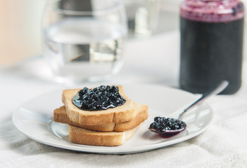 Toast with jam on white background