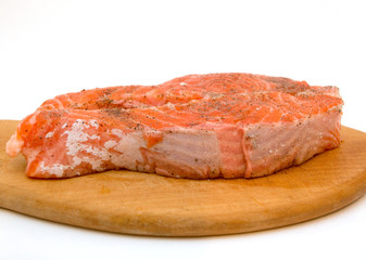 Trout steak on a wooden hardboard ready to cook