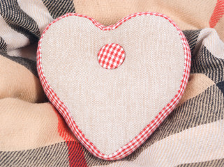 Fabric linen handmade heart on a warm scarf