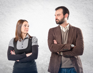 Couple with their arms crossed over isolated background