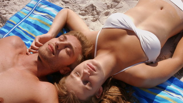 Happy couple relaxing on the beach
