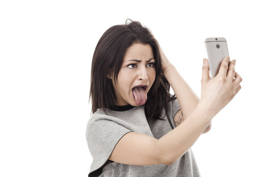 Funny woman making a grimace and taking a selfie