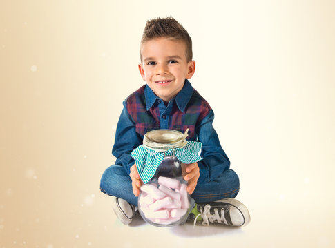 Kid Holding A Glass Jar With Sweets Inside