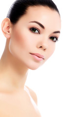 Fototapeta premium Face of a beautiful young woman, white background, isolated, cop