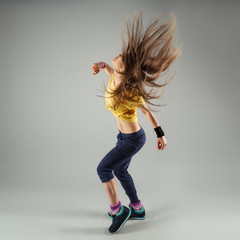 Young energetic zumba fitness woman dancer moving in class