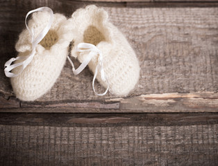 baby's bootee  on wooden background