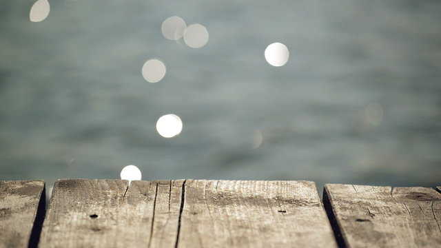 Old Wooden Pier Jetty and Metal Ladder on River, Water Sparkling