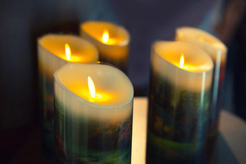 Burning candles on dark background