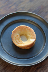 One piece of yorkshire pudding on a tin plate.