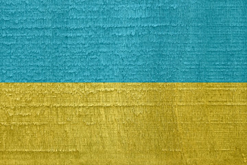 Flag of Ukraine on old dried wood texture