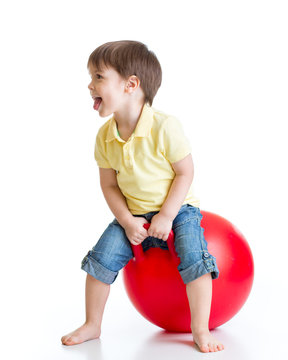 Happy Child Jumping On Bouncing Ball