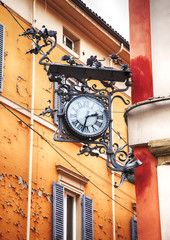 Fototapeta na wymiar street clock as decorative element in Bologna