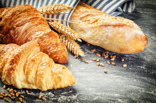 Freshly baked baguette and croissants in rustic setting