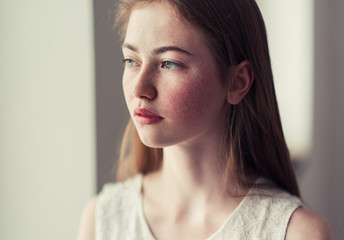 portrait of a beautiful girl near the window