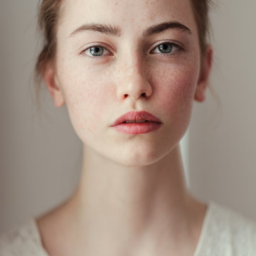 Portrait of young woman with freckles