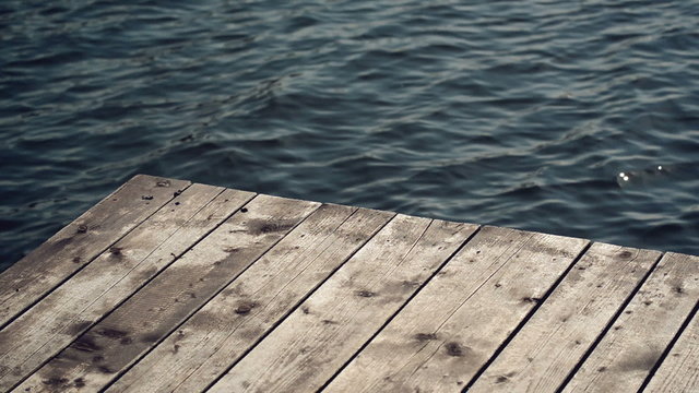 Old Wooden Pier Jetty and Metal Ladder on River, Water Sparkling