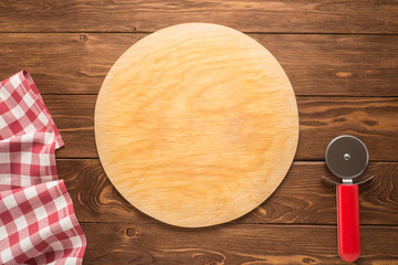 Pizza cutting board with tablecloth and round knife