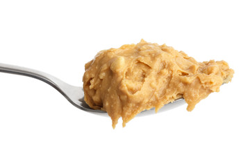 Crunchy peanut butter on metal spoon.