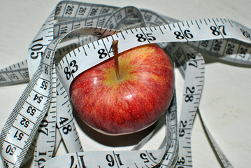 red apple with measuring tape