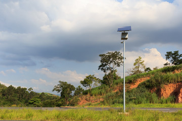 Electric pole with solar panel on road in countryside, use of So