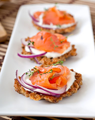 Buckwheat pancakes with salted salmon and sour cream close up