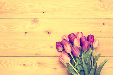 Tulips on wooden texture