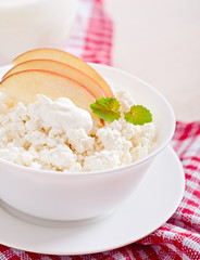 Cottage cheese with apples and sour cream for breakfast close up