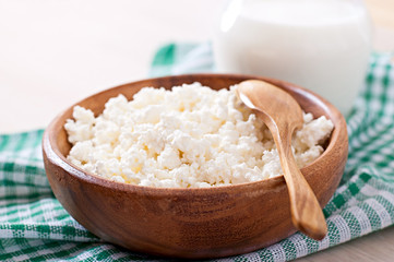 Cottage cheese with apples for breakfast in wooden bowl close up