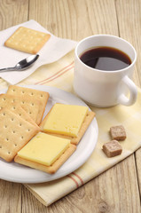 Cracker cookies with cheese and coffee