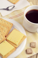 Cracker with cheese and coffee