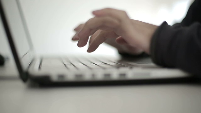 Intelligent man works at the computer in studio